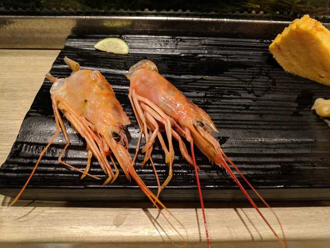 Two well sucked prawn heads.