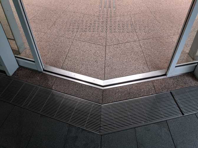 The sliding doors at the front entrance, which meet at an angle. I went back
for a picture of this.