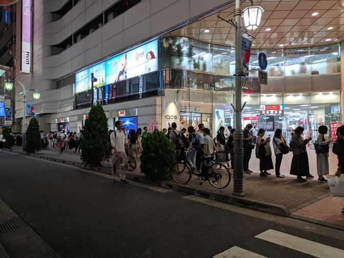 Ikebukuro: a picture of half of the line for a bus stop.