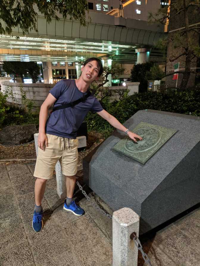 Touching the point which marks the centre of Tokyo, used for distance
measurements.