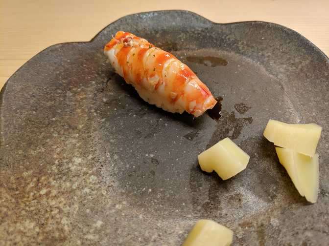 Kuruma ebi (prawn) with lime peel: Hatori-san asked us for any extra orders
that we wanted, so Jack and I asked for prawn. Unfortunately, we didn't forgot
how to say "raw" at the time, and Hatori-san didn't understand us. It might be
the tastiest cooked prawn sushi that I've eaten, but it's still cooked 😔.