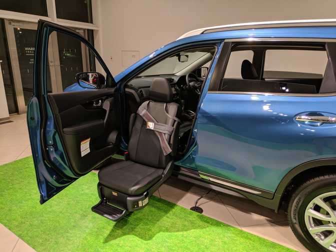 An accessible car seat that electronically lowers and raises/rotates.