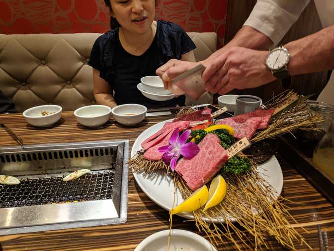 Grinding salt onto another plate of meat that Bob's aunt sneakily ordered.
Asian hospitality...