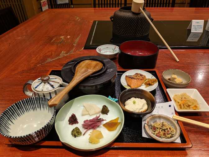 The waiter poured water into the pot on the stove in the middle of the
table. The teapot had green tea leaves and the lidded container had white
rice. I was supposed to scoop hot water into the teapot, put all the food
into the mixing bowl on the bottom left, then pour the tea on top. I liked
the clean taste but it wasn't as amazing as the last chazuke I had, probably
due to the mild taste of the tea. The fish was good and tasted a bit like
lapcheung (Chinese sausage).